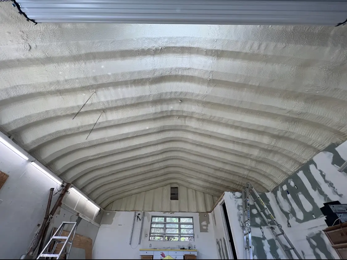 Spray polyurethane foam applied to the underside of a metal roof deck in Atlanta